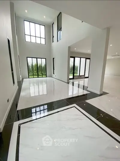 Luxurious modern living room with high ceilings and large windows