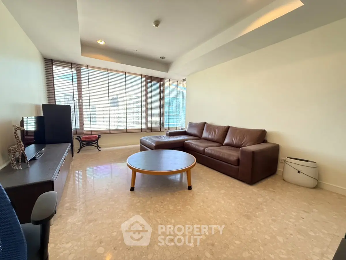 Spacious living room with large windows and modern furniture