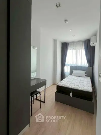 Modern bedroom with minimalist design, featuring a comfortable bed, sleek furniture, and ample natural light.