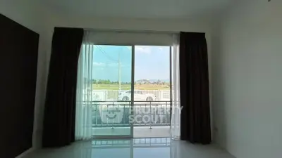 Spacious room with large window offering scenic view and natural light.