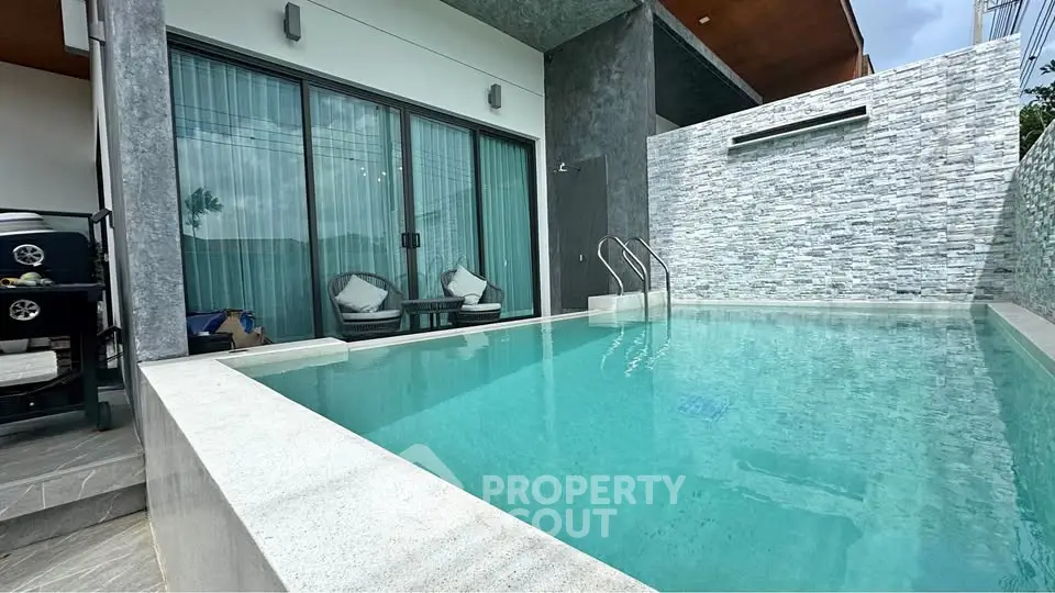 Luxurious modern home with private pool and stylish outdoor seating area.