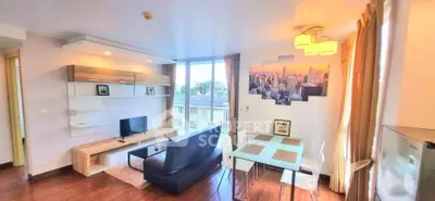 Modern living room with city view, stylish decor, and ample natural light.