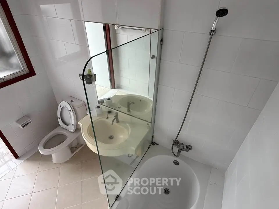 Modern bathroom with glass shower and white fixtures