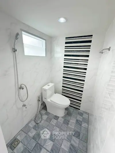 Modern bathroom with sleek design and striped accent wall