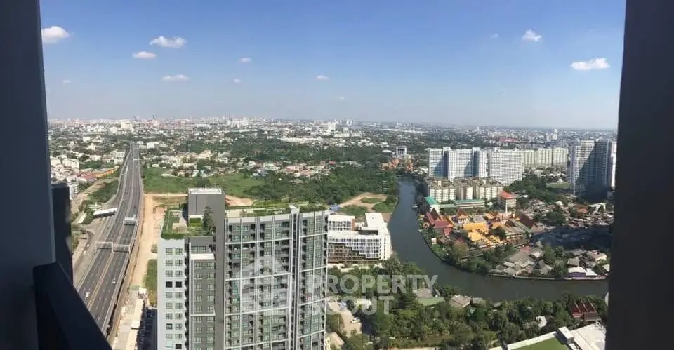 Stunning high-rise cityscape view from a modern balcony overlooking urban skyline and river.