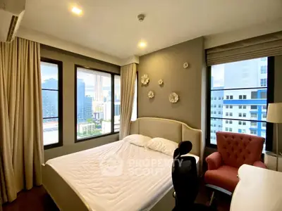 Cozy bedroom with city view, featuring a comfortable bed and stylish decor in a modern apartment.