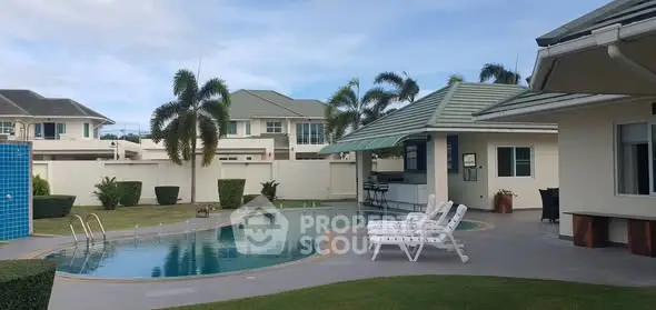 Luxurious villa with private pool and lush garden in tropical setting.