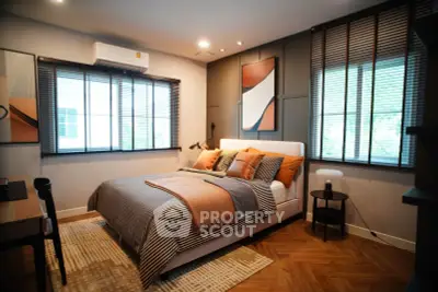 Modern bedroom with stylish decor and natural light, featuring a cozy bed and elegant furnishings.