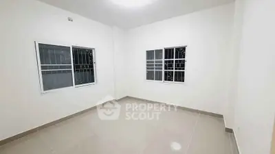 Spacious unfurnished room with tiled flooring and large windows, perfect for customization.