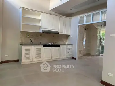 Spacious kitchen with open layout and modern cabinetry in a bright home.