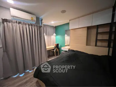 Modern bedroom with study area, featuring sleek design and ample natural light.