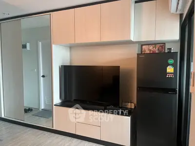 Modern living room with sleek TV setup and stylish cabinetry