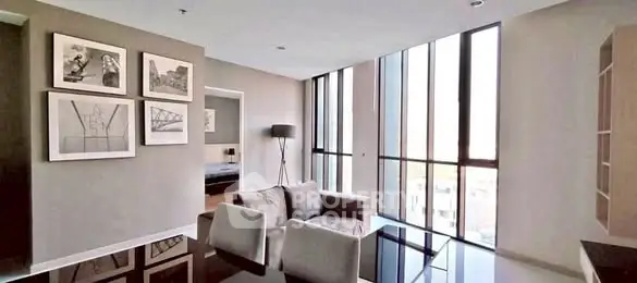 Modern living room with large windows and stylish decor