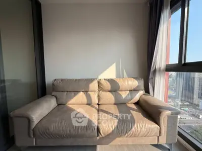 Modern apartment balcony with cozy beige sofa and city view