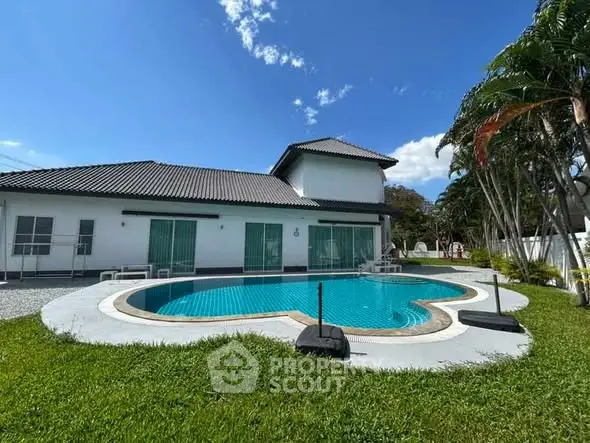 Luxurious villa with unique heart-shaped pool and lush garden, perfect for relaxation and entertaining.