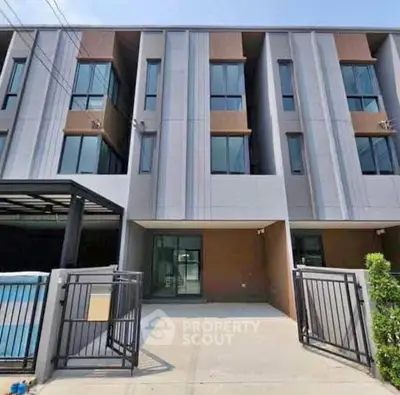 Modern townhouse exterior with sleek design and gated entrance