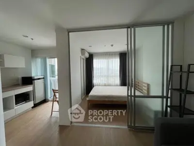 Modern studio apartment with sliding glass doors and natural light