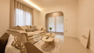 Elegant living room with cozy sofas and natural light, perfect for relaxation.