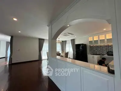 Spacious open-layout living room with elegant kitchen and dining area