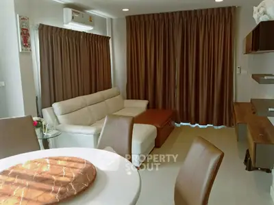 Modern living room with elegant brown curtains and white leather sofa
