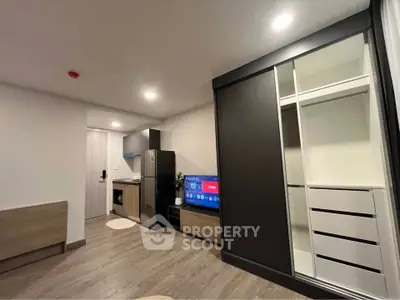 Modern studio apartment with sleek kitchen and built-in wardrobe