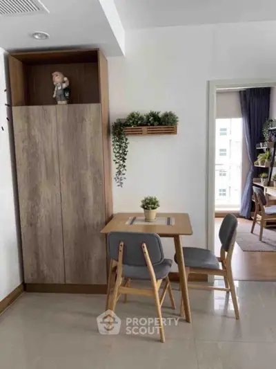 Cozy dining area with wooden table and chairs, featuring modern decor and natural light.