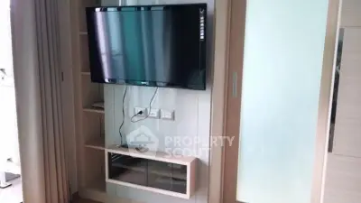 Modern living room with wall-mounted TV and sleek storage unit