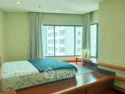 Spacious bedroom with large windows and modern decor in a high-rise apartment.