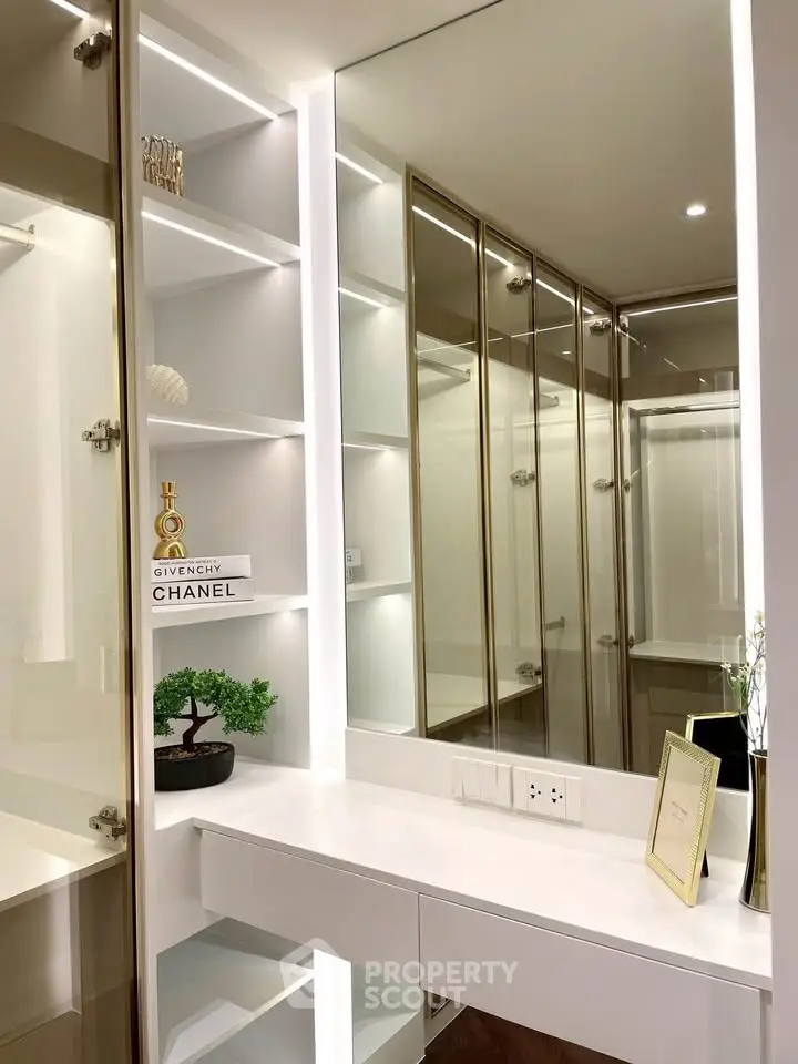 Luxurious modern dressing area with sleek cabinetry and elegant lighting.