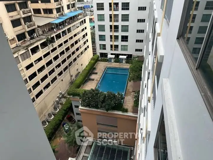 High-rise building with a rooftop pool offering a city view, perfect for urban living.
