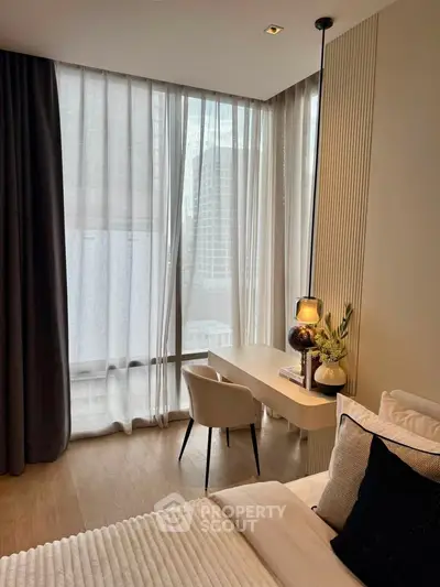 Modern bedroom with floor-to-ceiling windows and elegant decor in urban apartment.