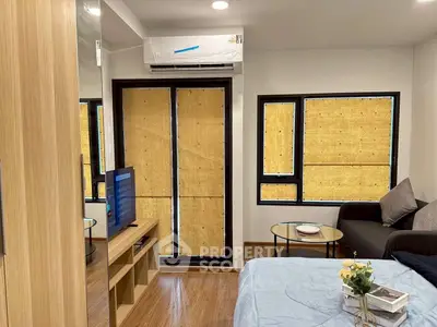 Modern living room with cozy sofa, TV, and air conditioning in a stylish apartment.