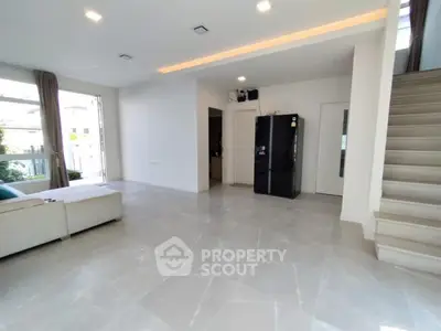 Spacious modern living room with sleek tile flooring and large windows