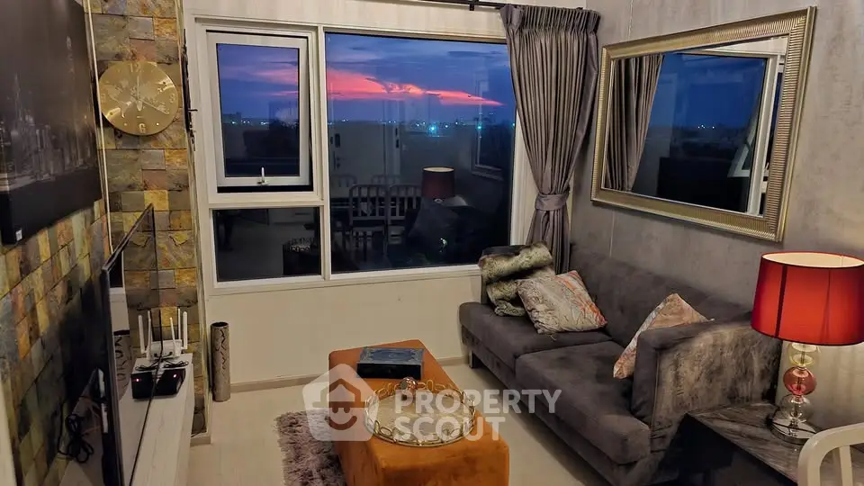 Chic living room with stunning sunset view, modern decor, and cozy ambiance.
