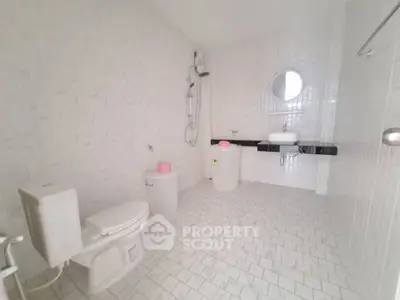 Spacious minimalist bathroom with modern fixtures and white tile design