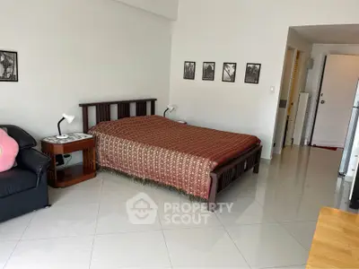 Spacious bedroom with modern decor and sleek tiled flooring