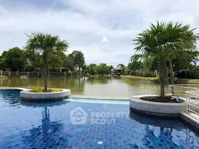 Luxurious poolside view with serene lake and lush greenery, perfect for relaxation and leisure.