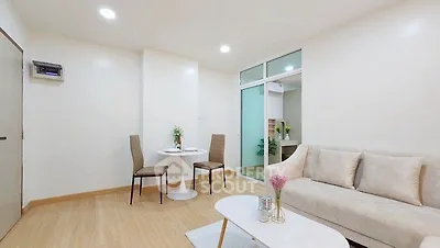 Modern living room with cozy seating and elegant decor in a bright apartment.
