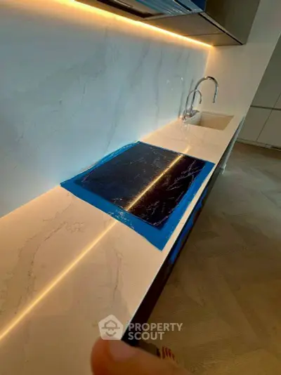 Modern kitchen with sleek marble countertops and built-in sink