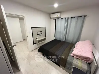 Cozy bedroom with modern decor and air conditioning in a stylish apartment.