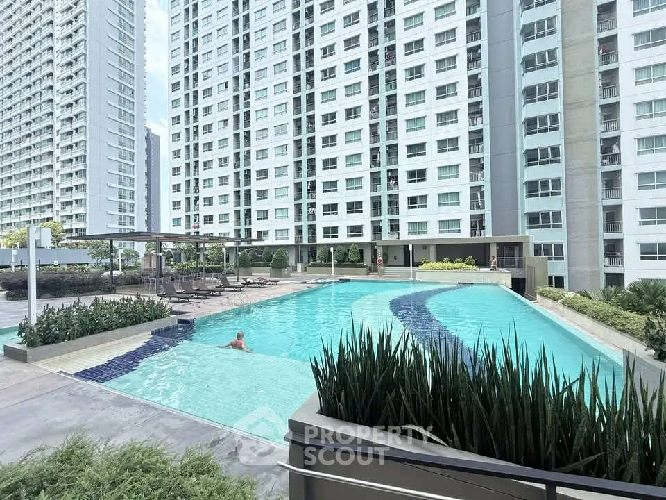Luxurious residential complex with a stunning outdoor pool and modern high-rise buildings.
