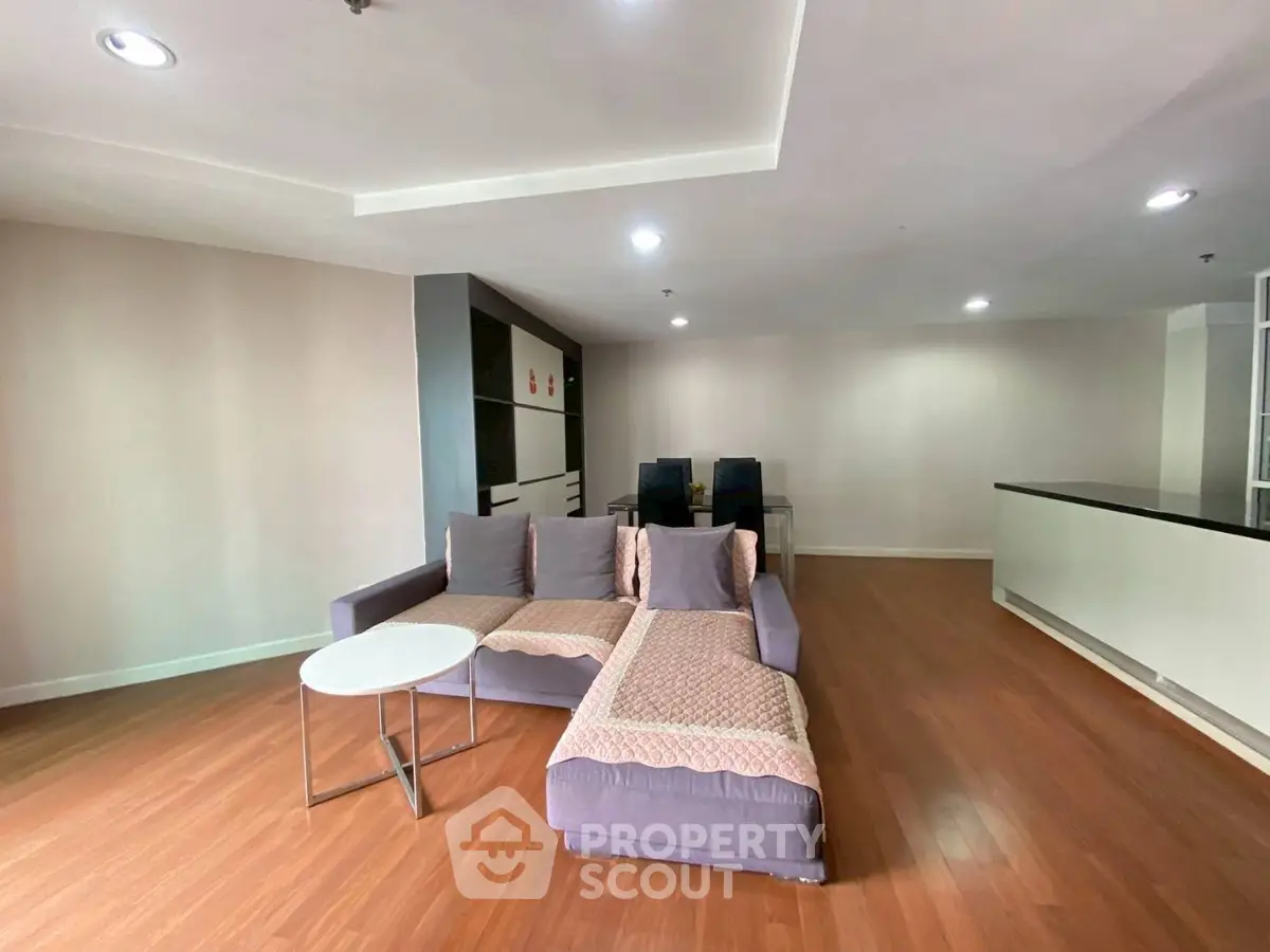 Spacious modern living room with stylish furniture and wooden flooring