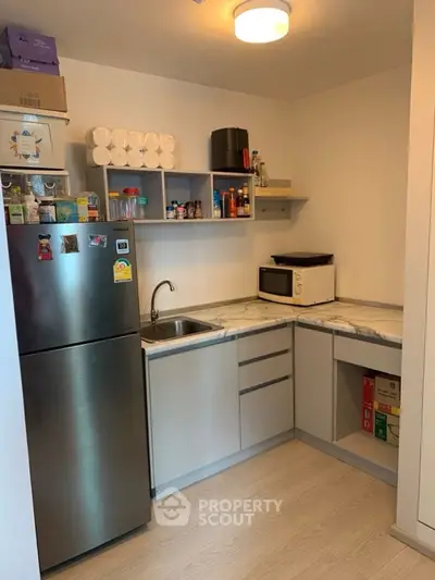 Compact kitchen with modern appliances and ample storage space