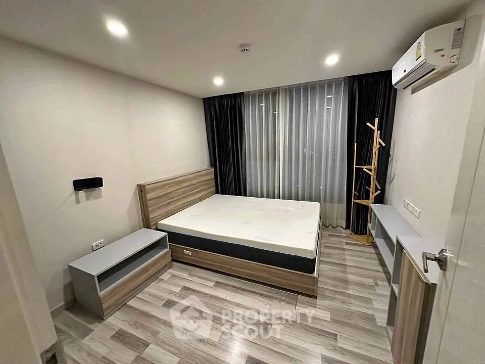 Modern bedroom with sleek design, featuring a comfortable bed, stylish furniture, and ambient lighting.