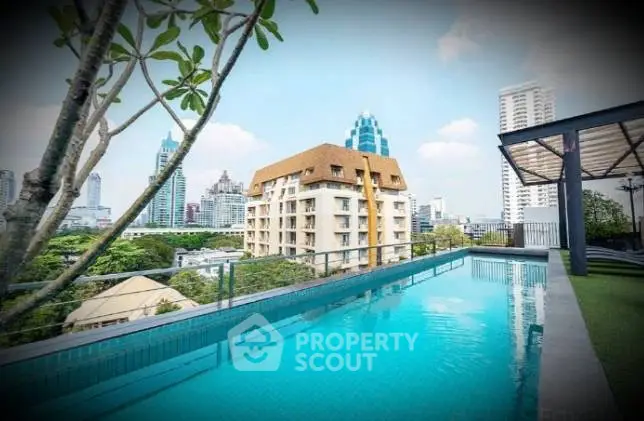 Stunning rooftop pool with city skyline views in a luxury apartment complex.