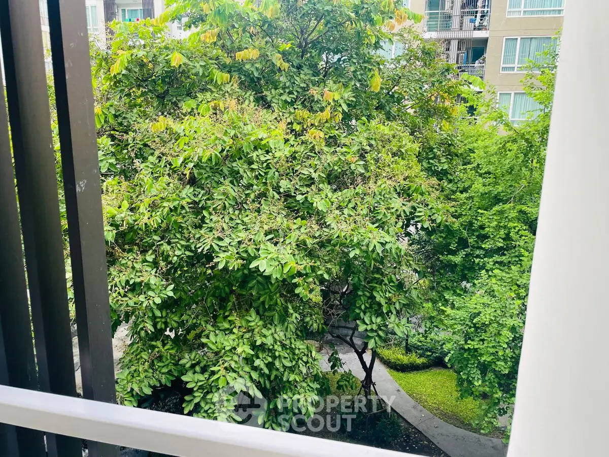 Lush garden view from a modern apartment balcony, perfect for nature lovers.