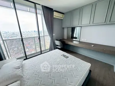 Modern bedroom with city view and sleek built-in desk, perfect for urban living.