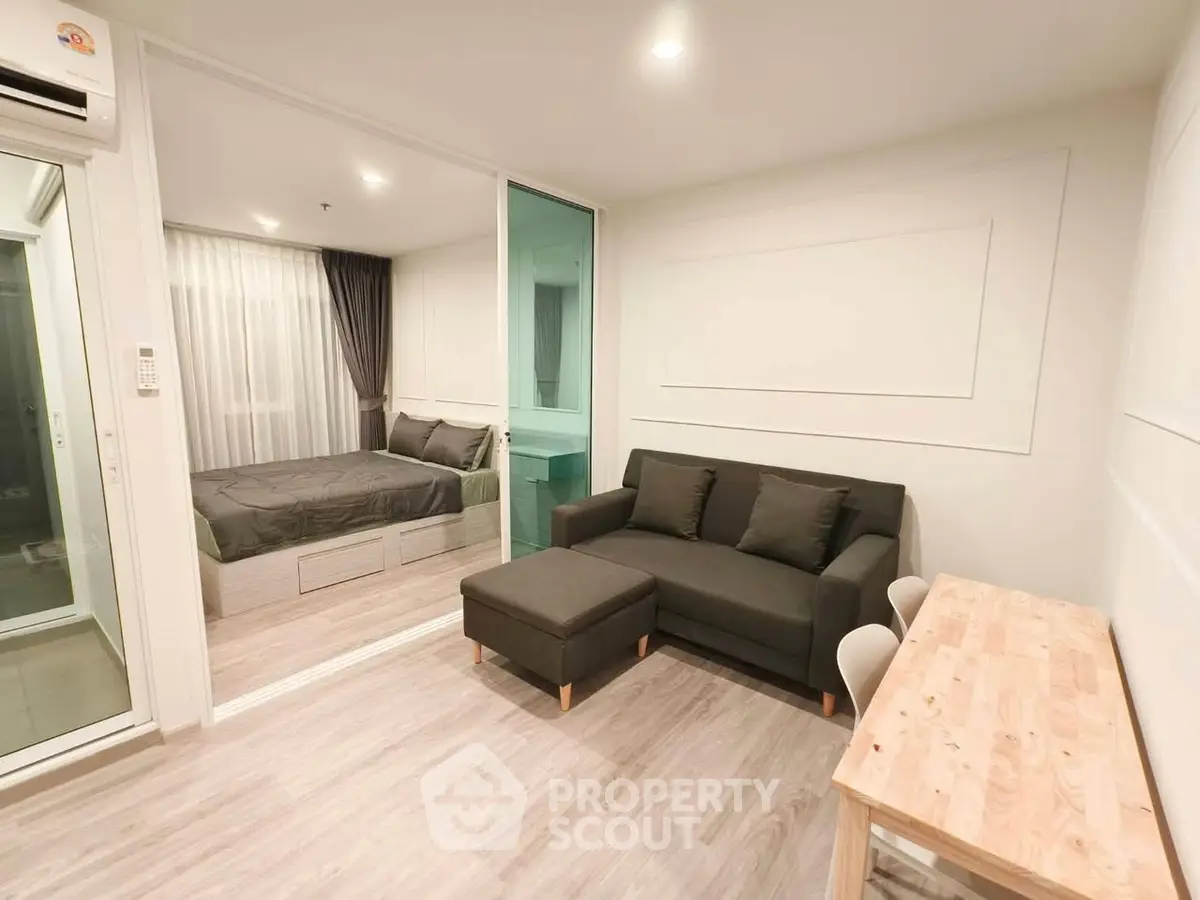 Modern studio apartment with cozy living area and stylish bedroom