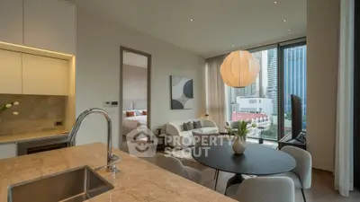 Modern open-plan living room with city view, elegant decor, and stylish kitchen area.