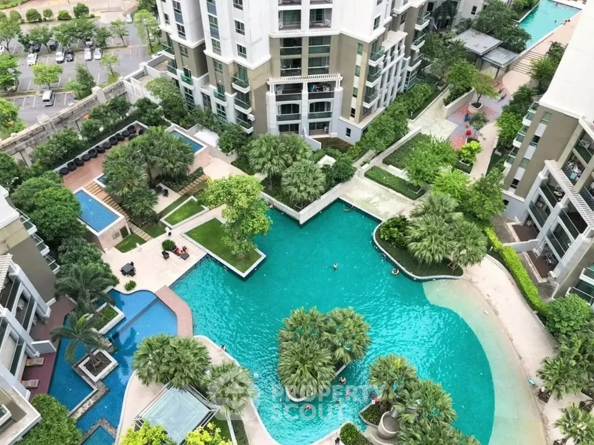 Luxurious residential complex with stunning pool and lush greenery